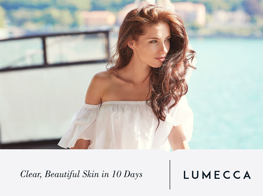 Beautiful woman with clear, radiant skin standing outdoors by the water, highlighting the results of Lumecca treatment at Revive Aesthetics Med Spa.